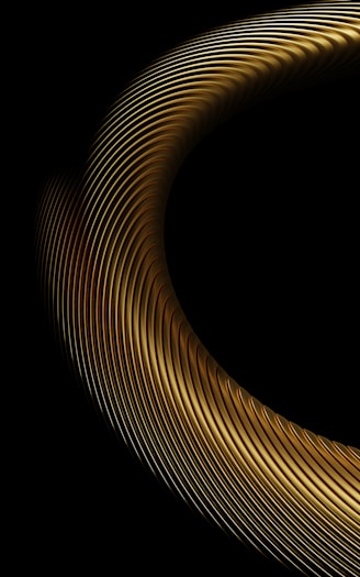 Abstract golden ring with ribbed texture on black background