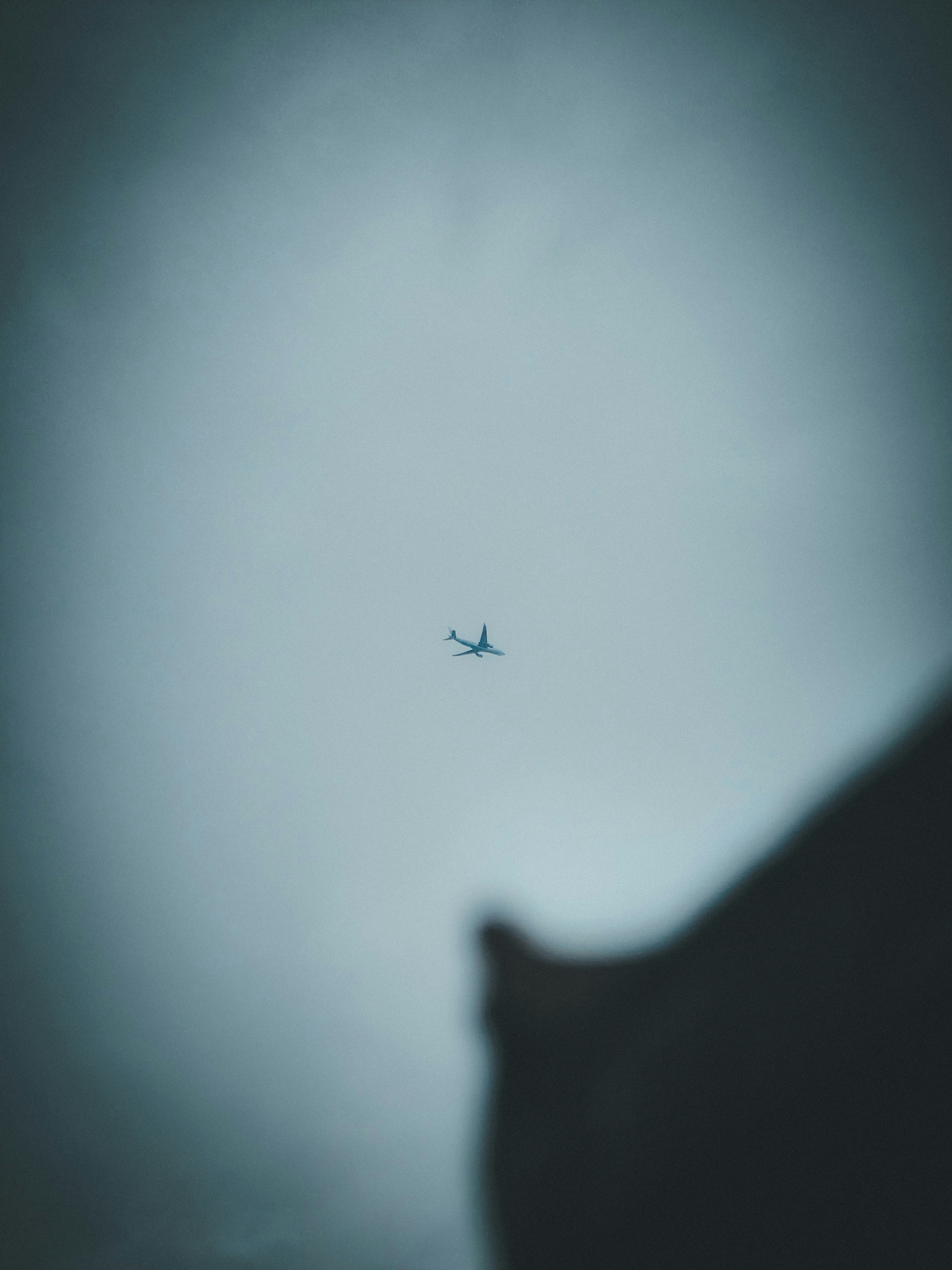 Small airplane flying in a cloudy sky.
