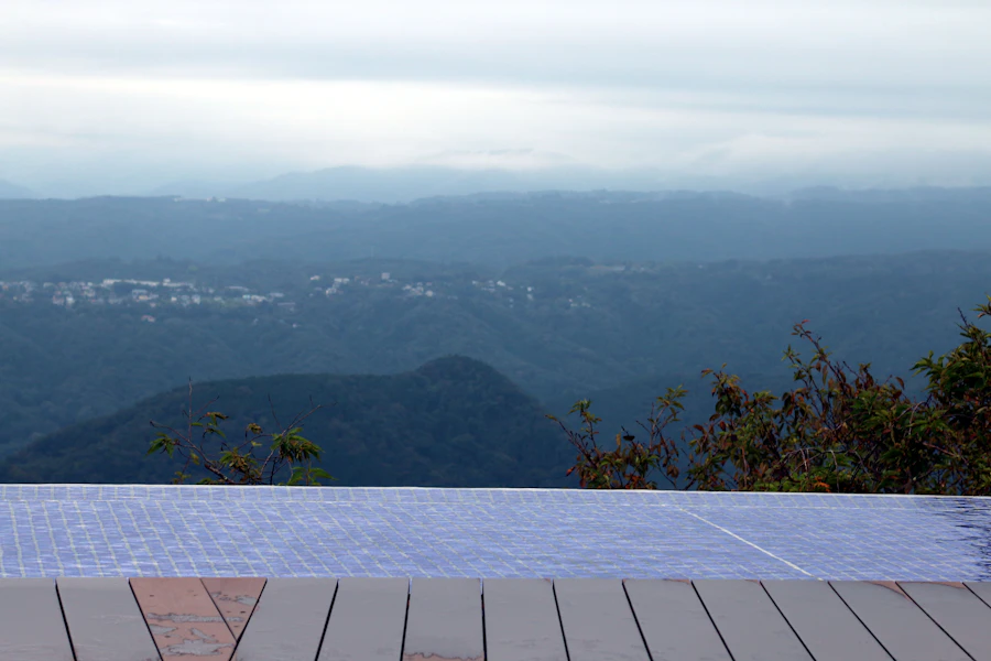Infinity pool overlooking misty mountains and a distant town