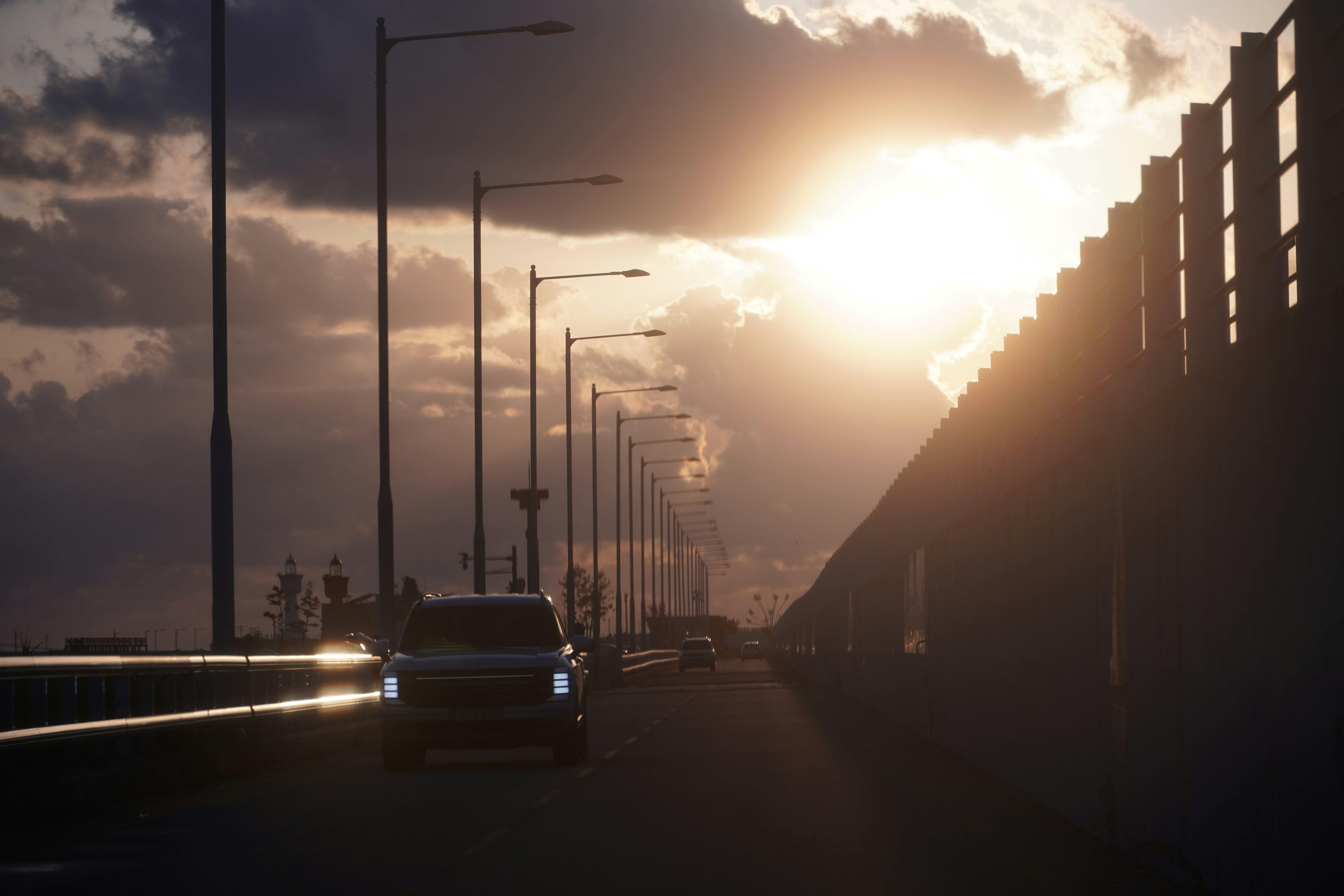 Car driving on a road at sunset