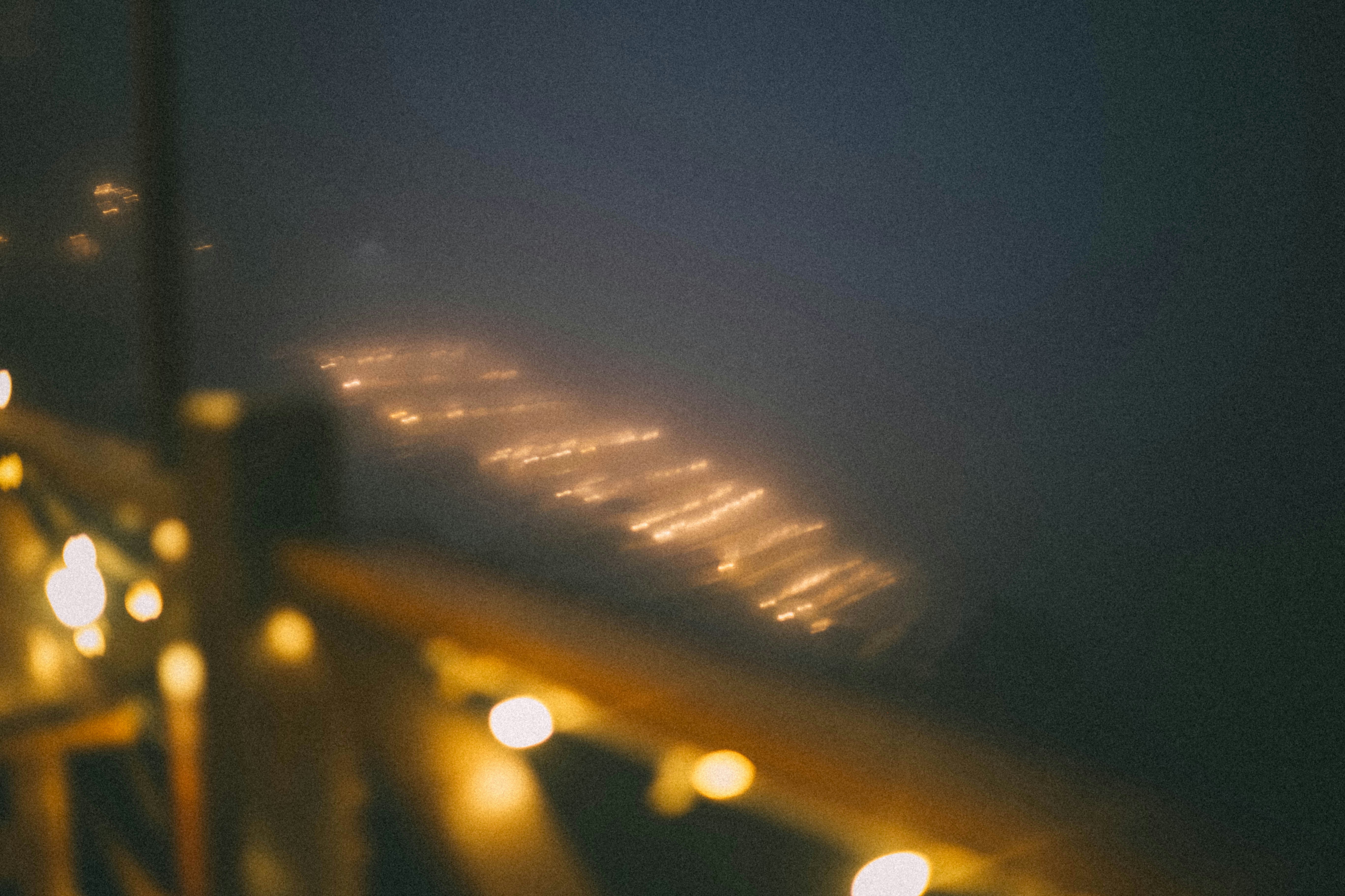 Blurred lights on a foggy night over water.