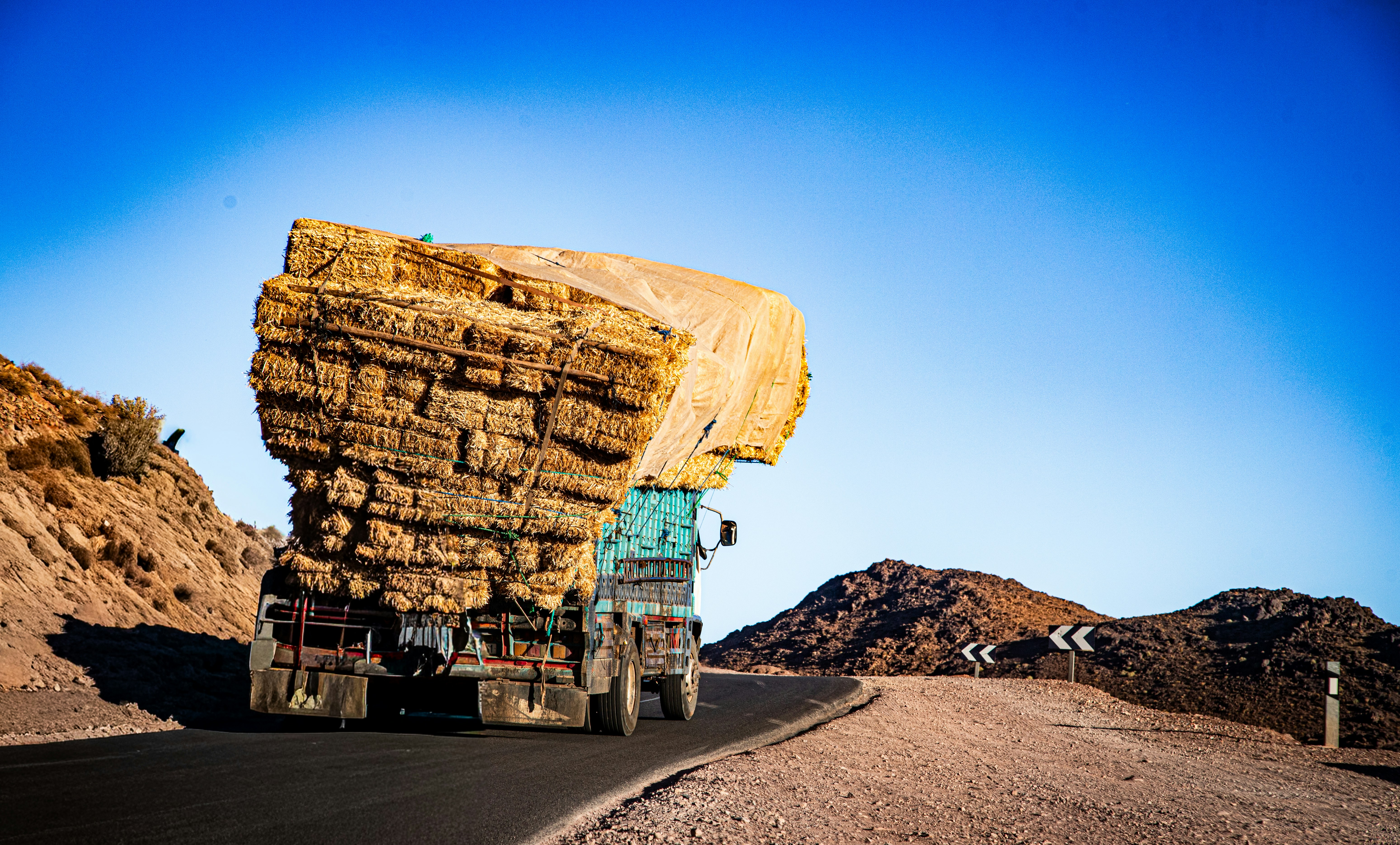 Truck with hay bales on desert road