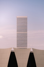 Modern skyscraper behind curved architectural elements