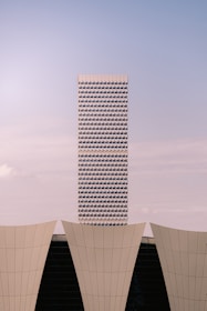 Modern skyscraper behind curved architectural elements