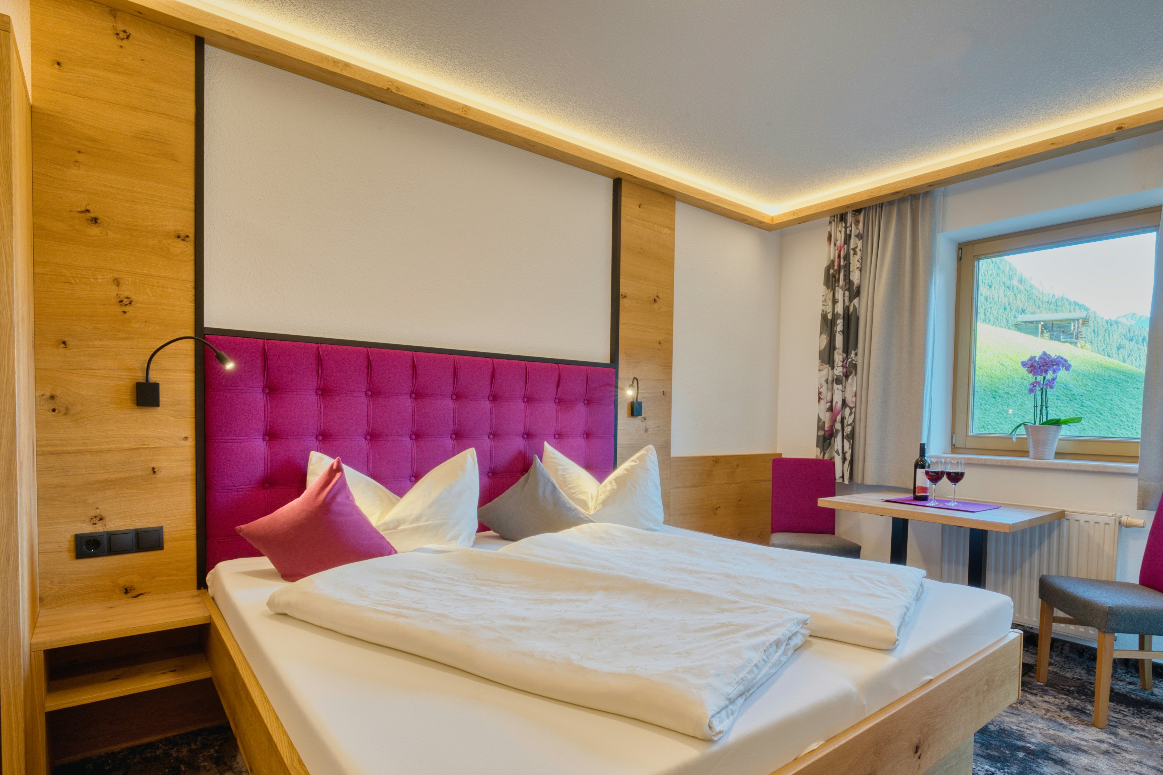 A cozy hotel room with a large bed and window.