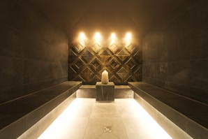 A modern steam room with a candle and ambient lighting.