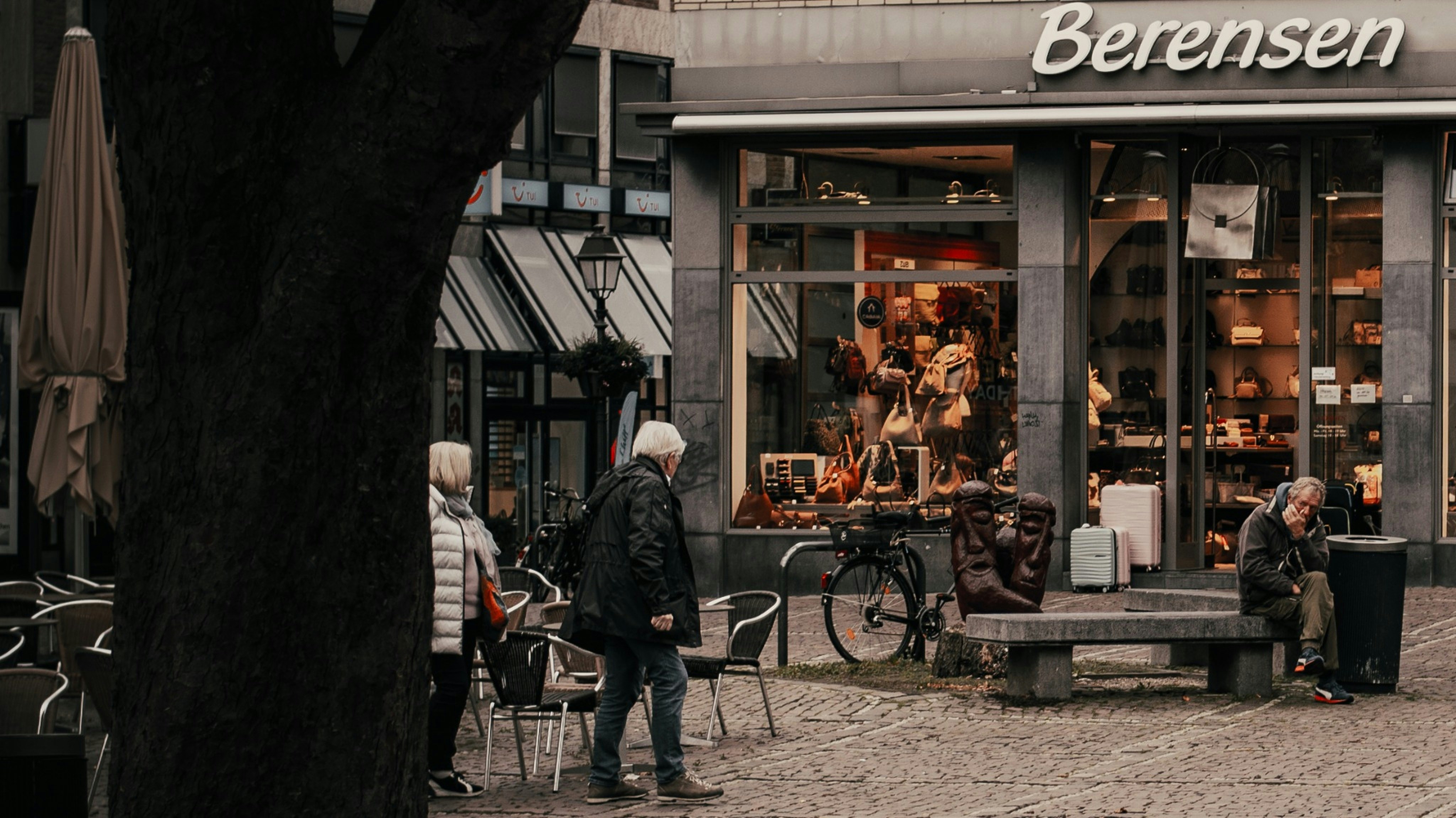 People outside a store with a bicycle