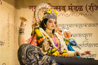 A statue of saraswati with a peacock