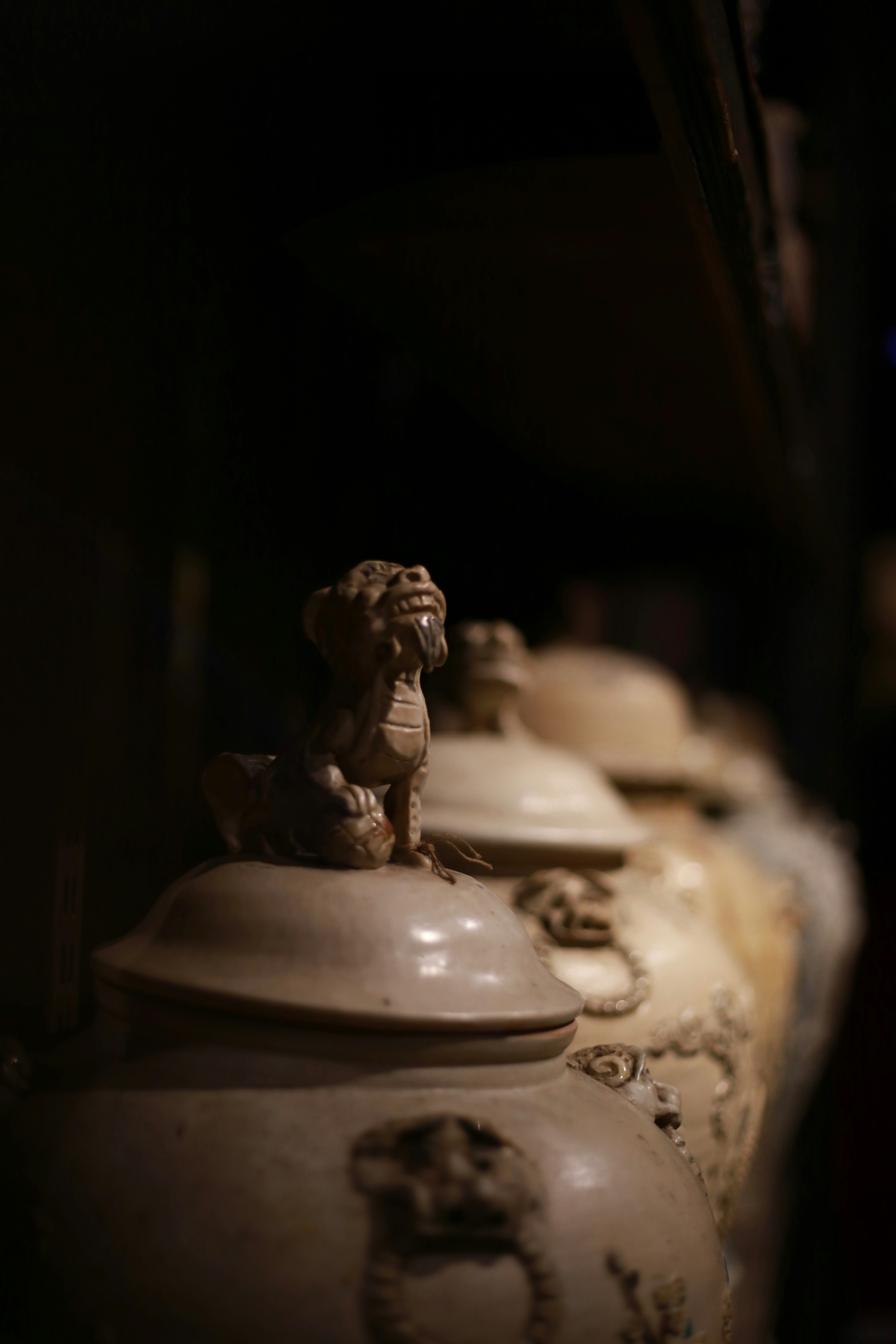 Row of antique jars with ornate lids