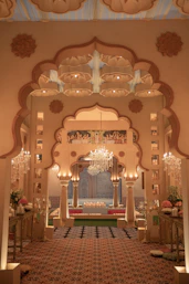 Ornate archway entrance with chandeliers and seating