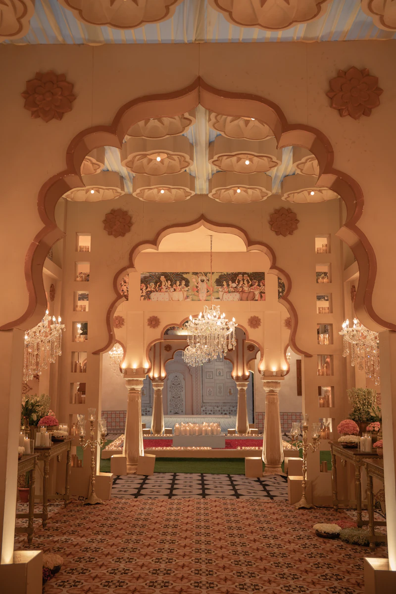 Ornate decorated archway entrance with chandeliers and seating at a wedding venue