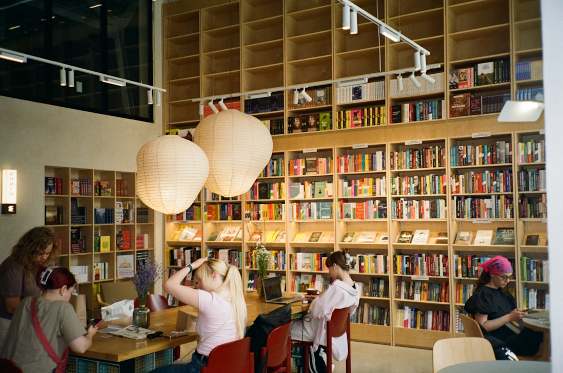 People browsing books in a well-stocked bookstore
