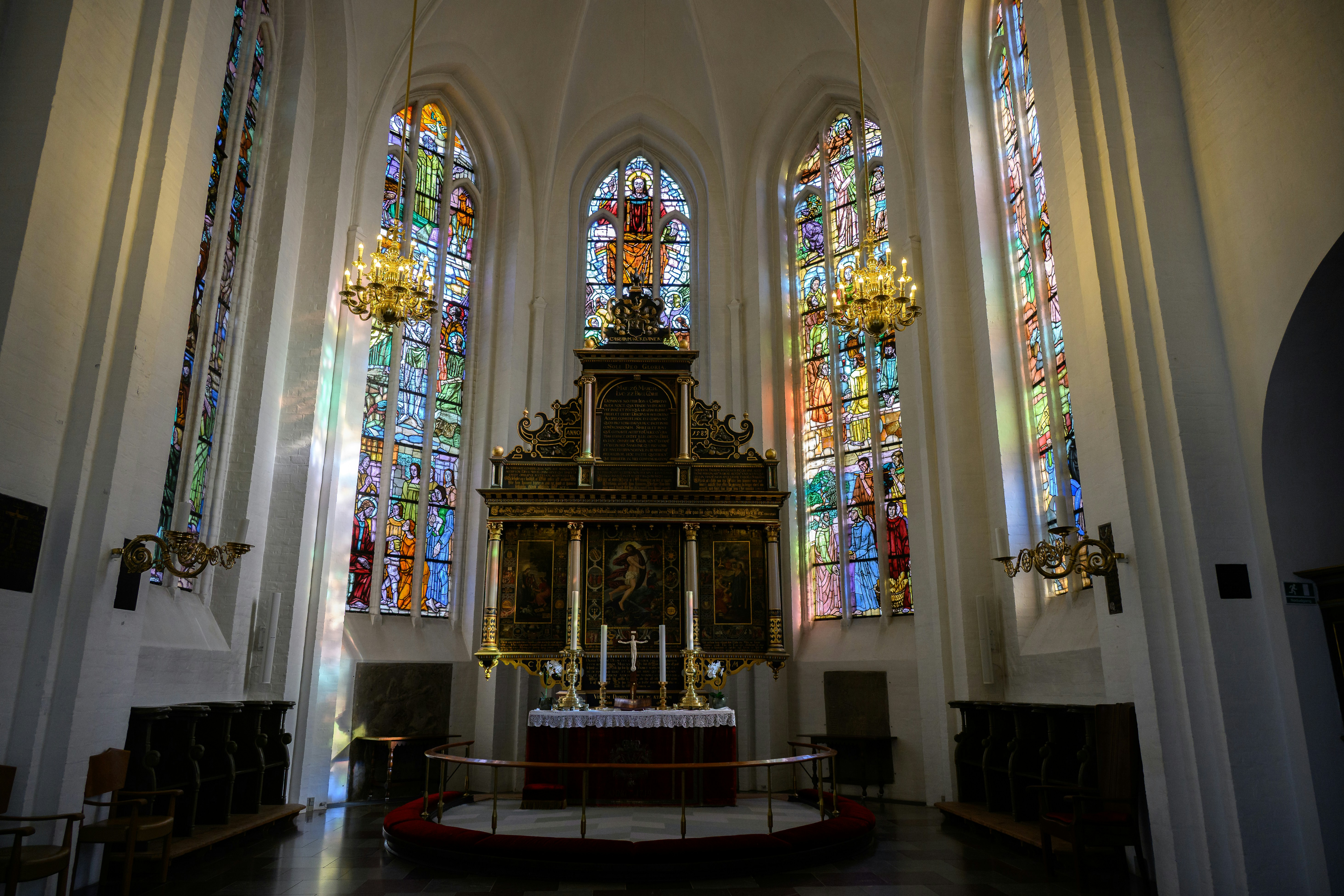 Altar and stained glass windows in a church