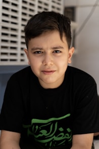 A young boy wearing a black t-shirt