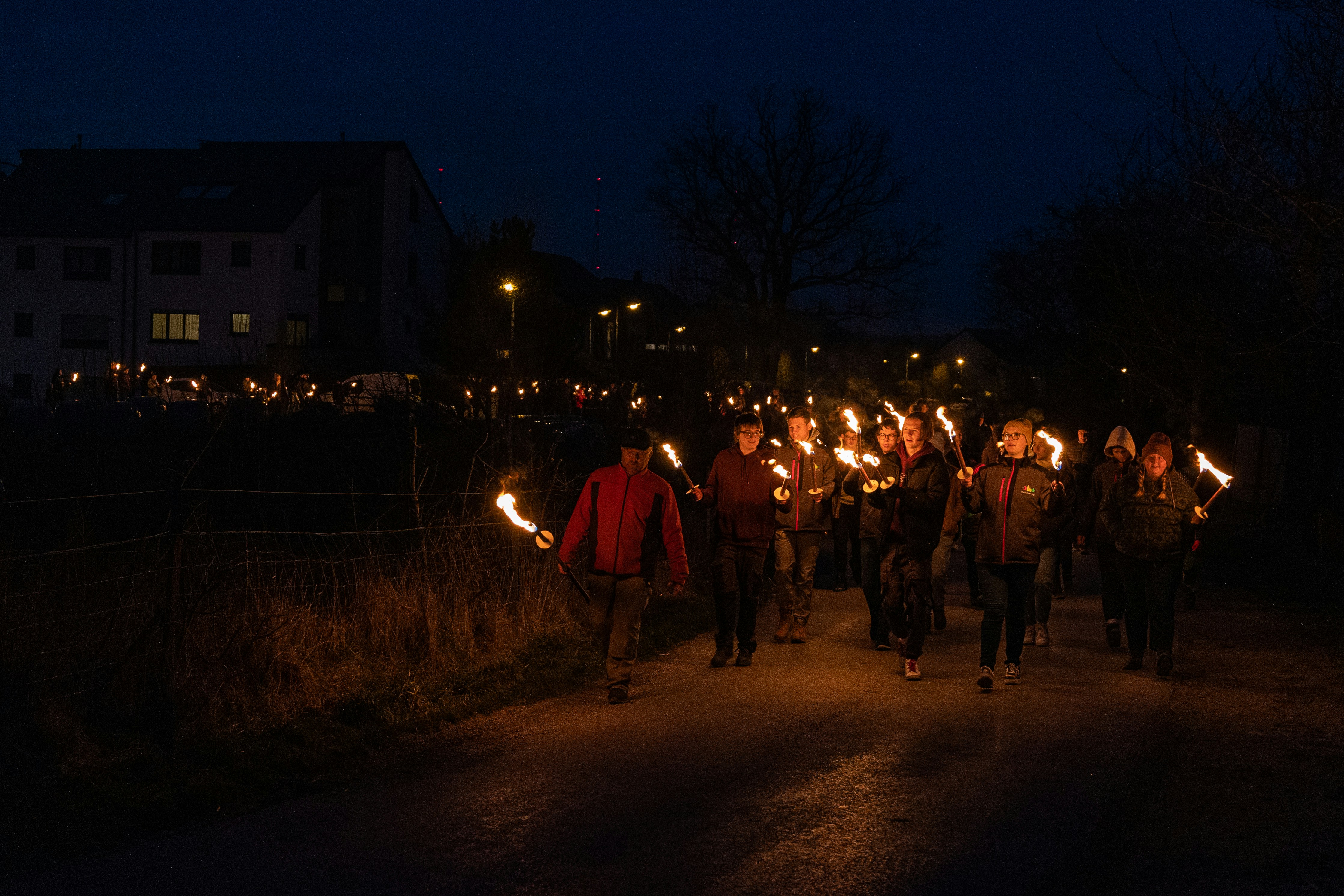 People marching at night with torches