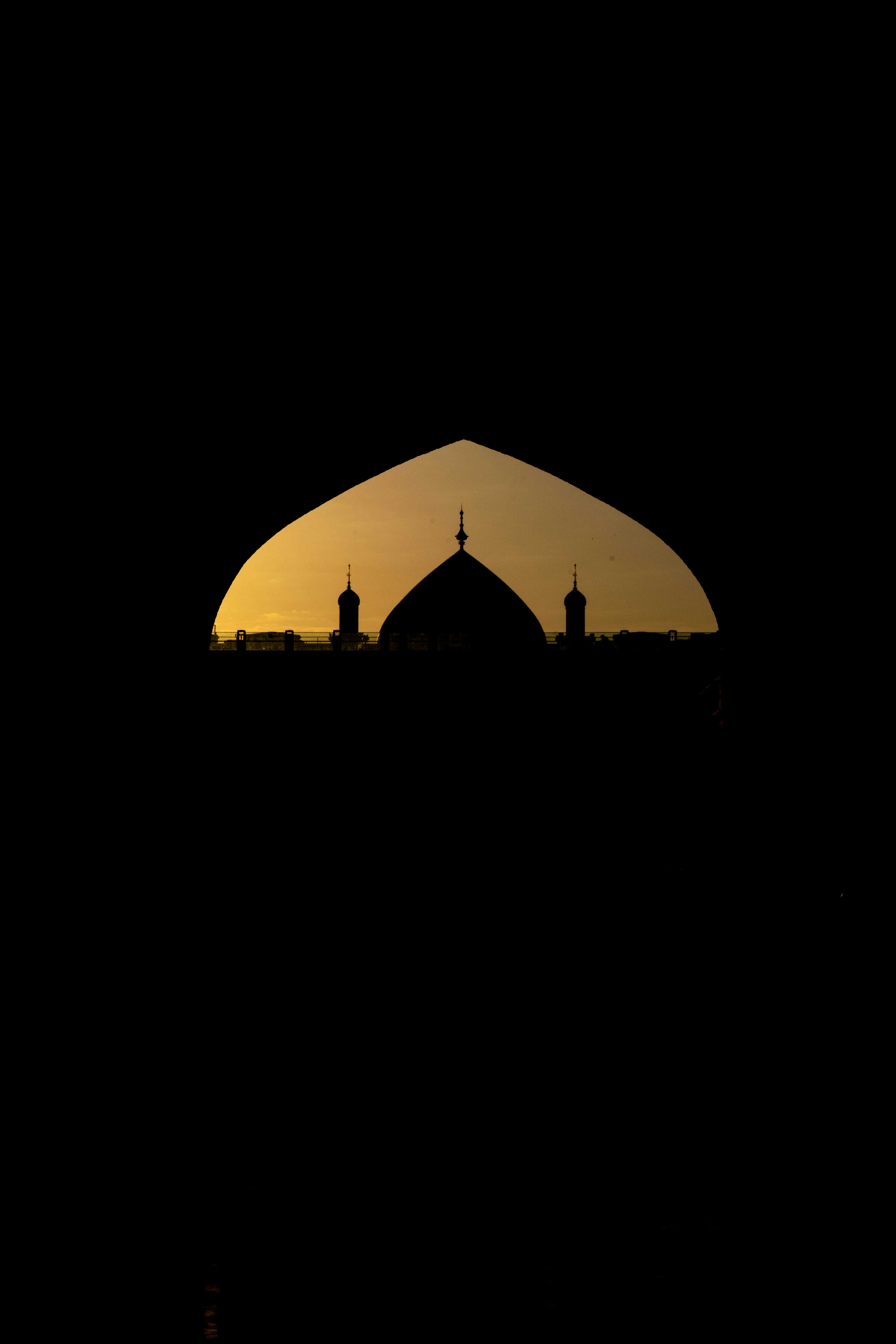 Silueta de mezquita contra un cielo dorado al atardecer