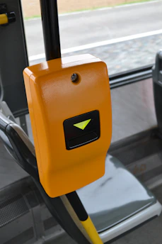 Orange ticket validator machine on a bus