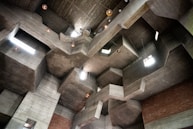 Geometric concrete architecture with angular shapes and lighting.