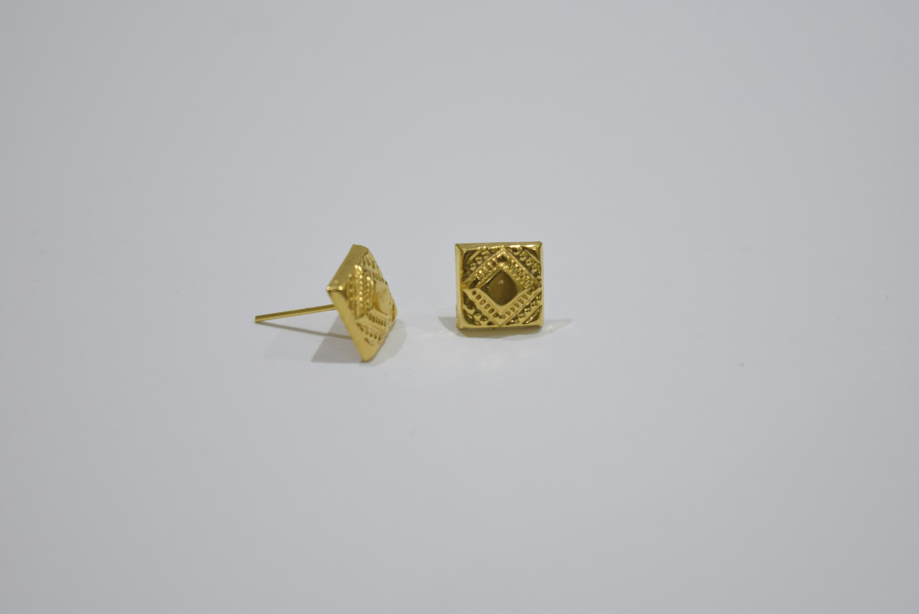 Pair of gold square stud earrings with pattern