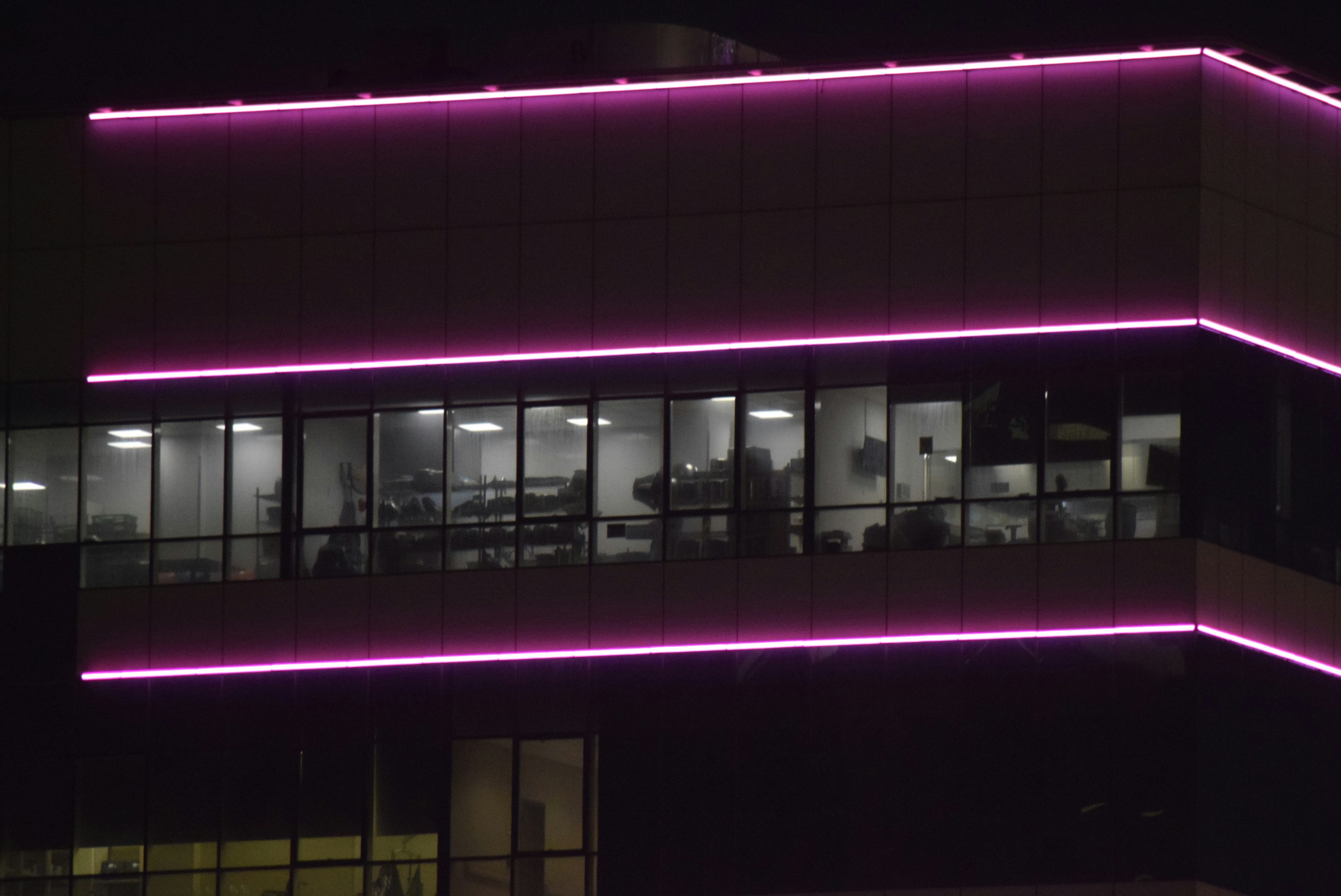 Modern building at night with pink neon lights
