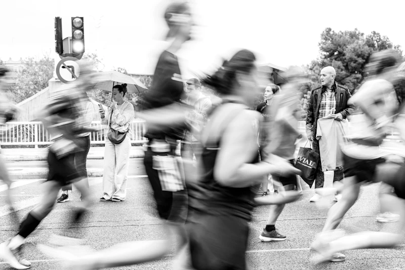 Blurred marathon runners racing past spectators on a city street (generic marathon photo, not verifiably the Chicago Marathon)