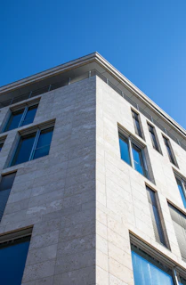 Modern building with stone facade and blue sky