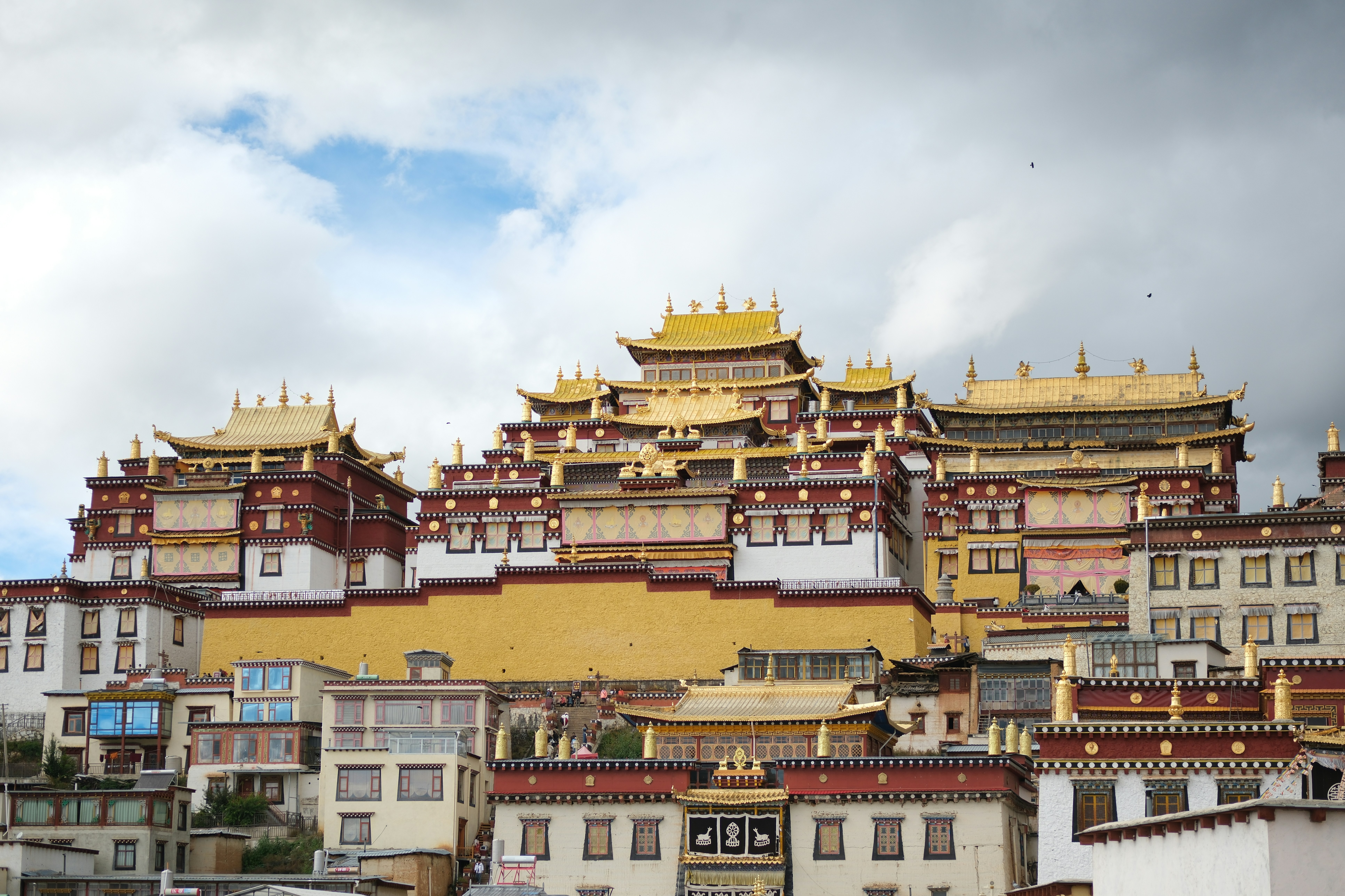 Golden roofed monastery complex on a hillside