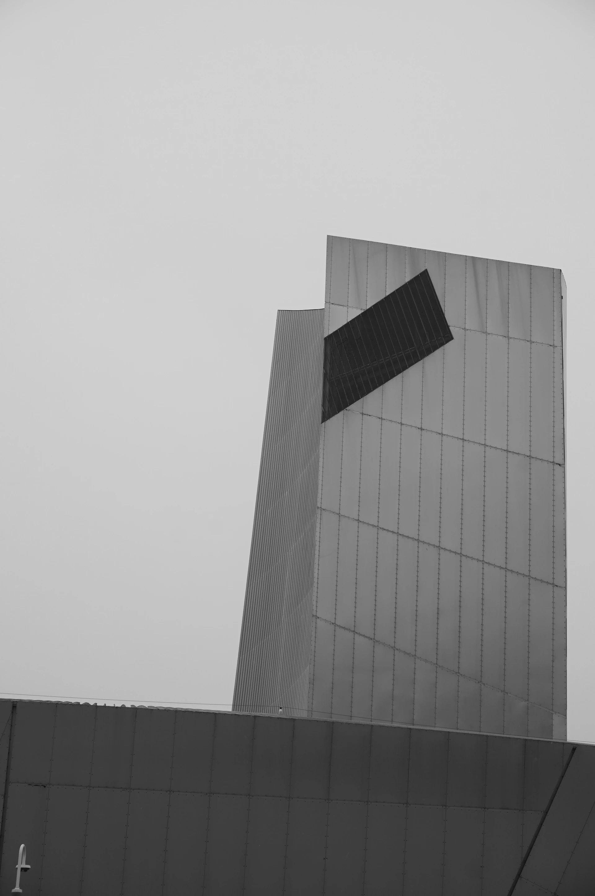 Modern building with geometric design against overcast sky