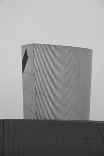 Modern building with metallic facade against sky