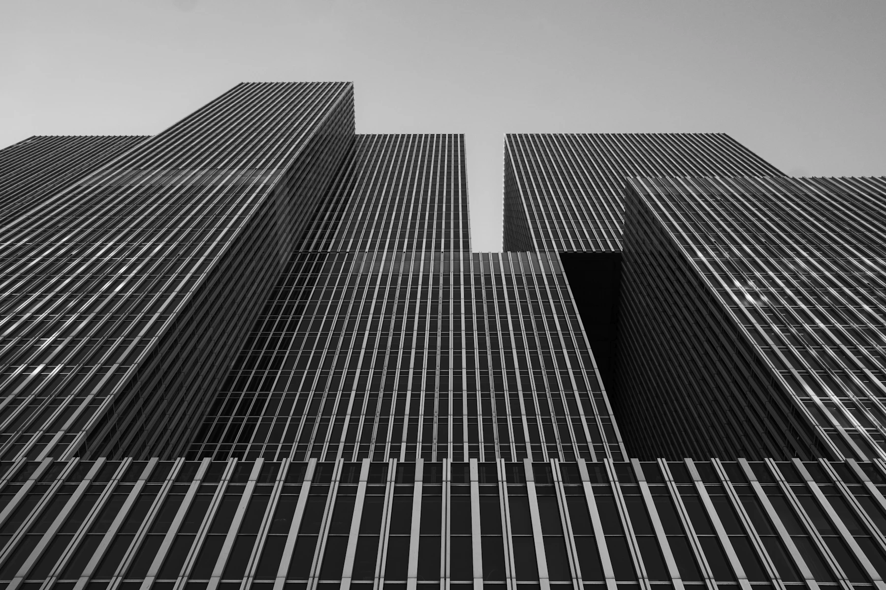Black and white view of modern high-rise architecture, photographed from below