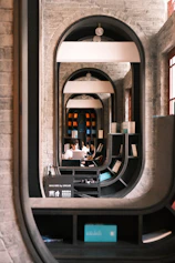 Person working in a modern library with arched doorways.