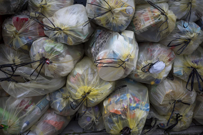 Commercial trash bags in black and clear grades stacked for facility waste management