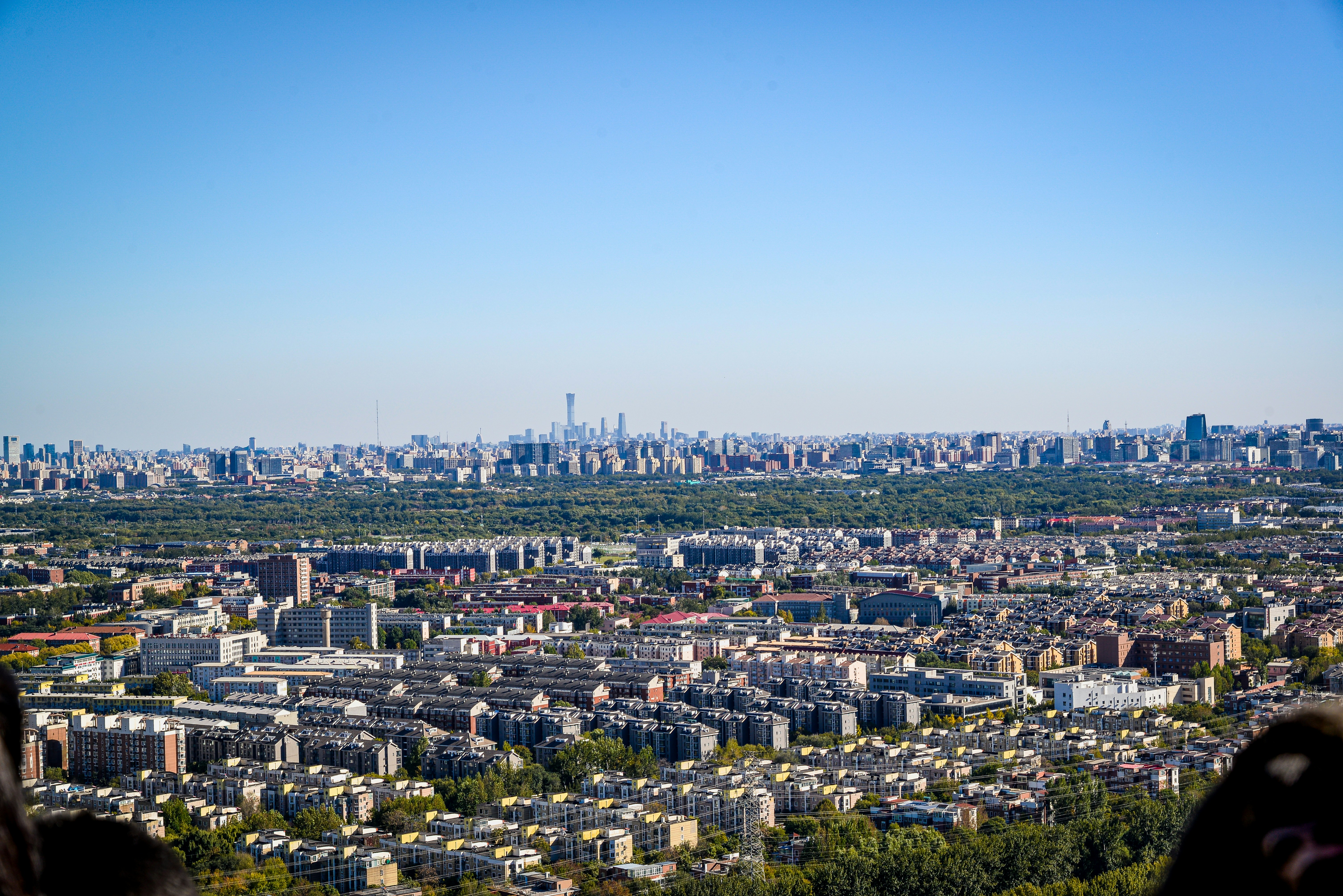 Expansive cityscape with dense buildings under clear sky.