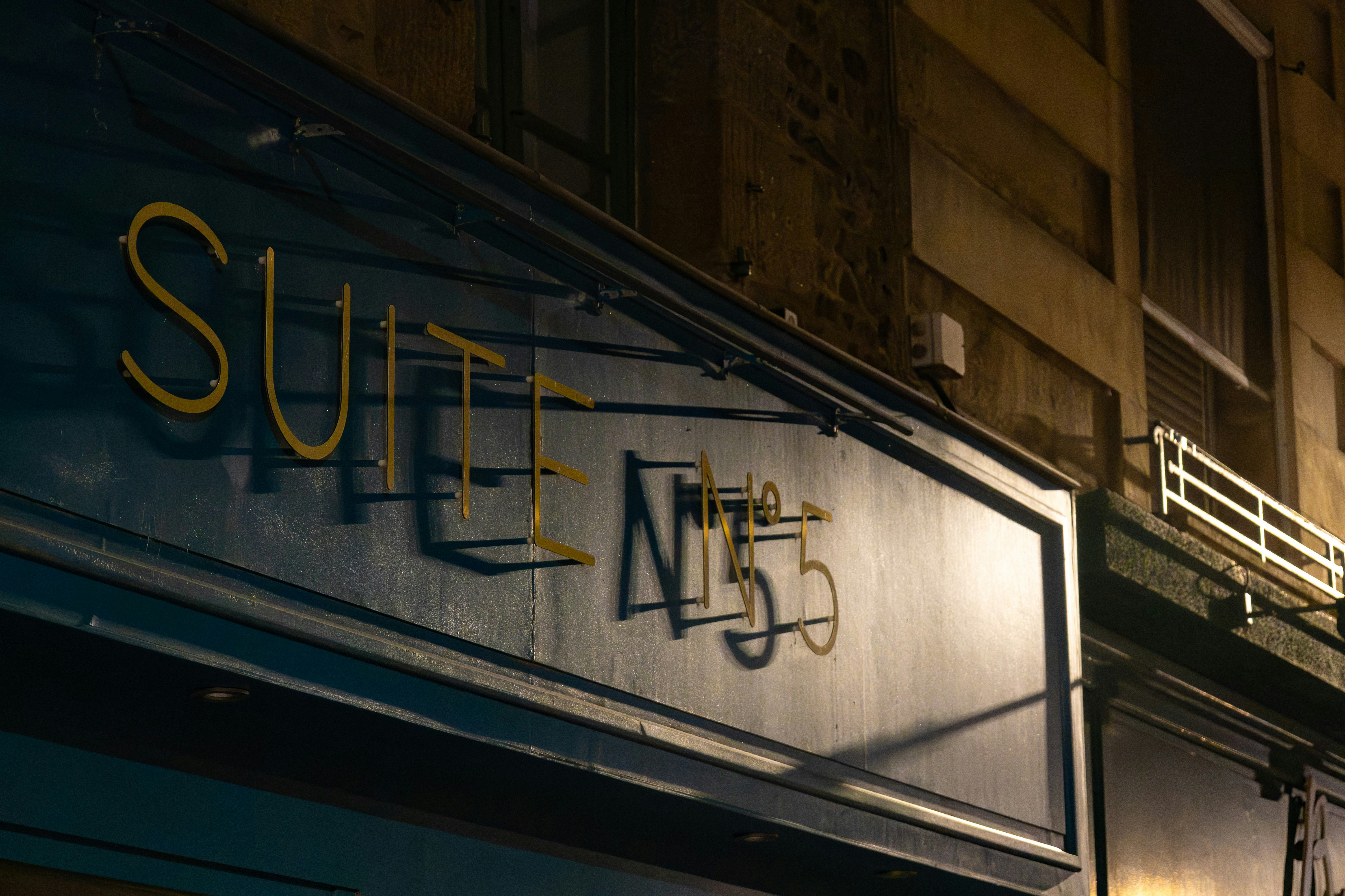 Building facade with suite n55 sign at night