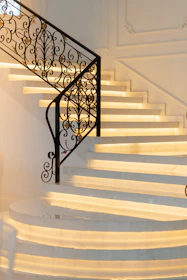 Elegant white marble staircase with ornate railing