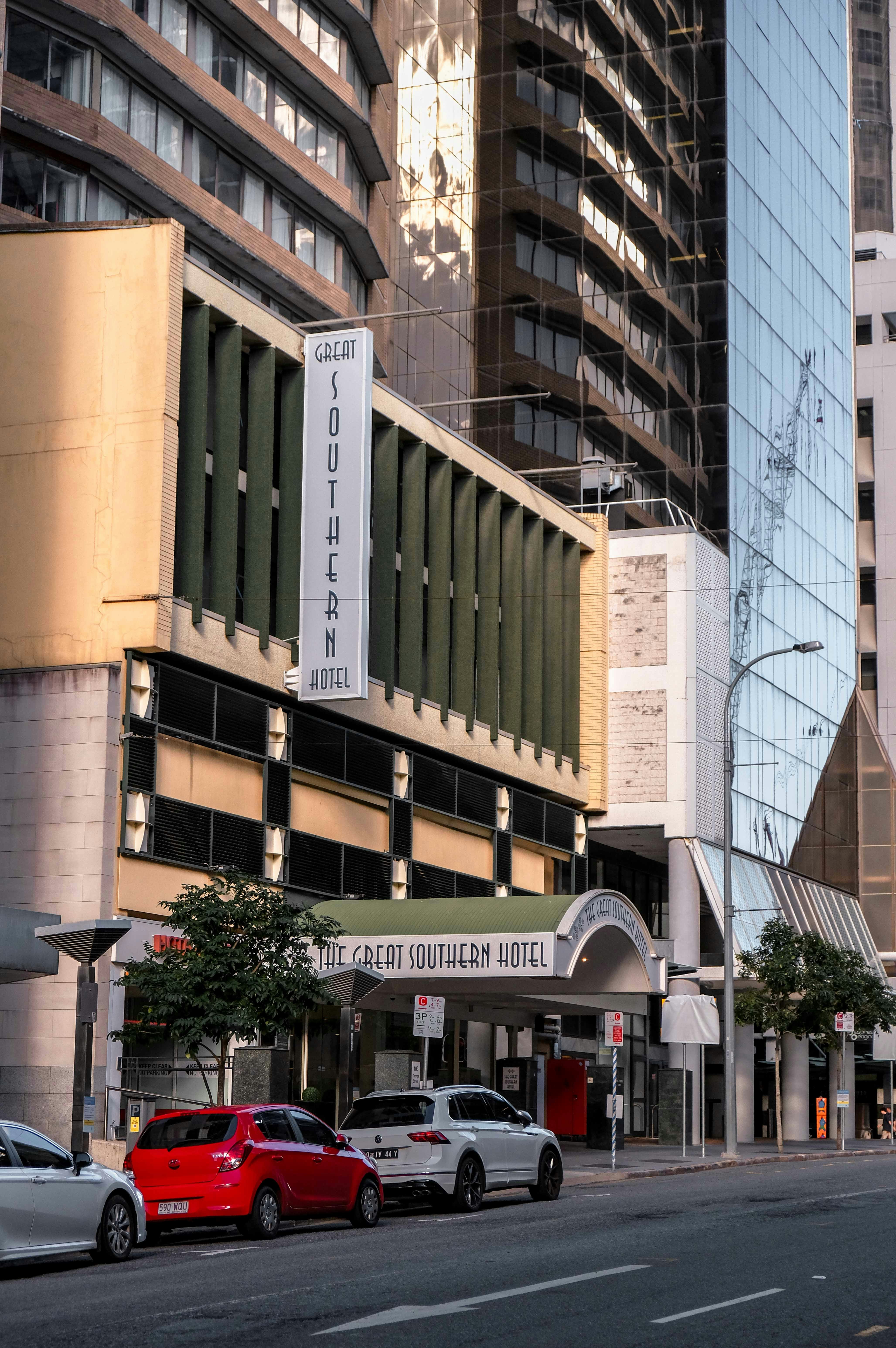 The great southern hotel entrance with cars parked outside.