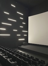Empty modern cinema hall with large screen and seats