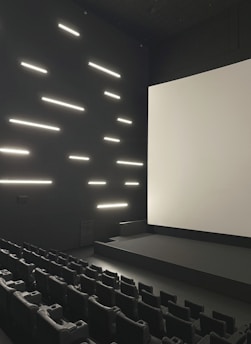 Empty modern cinema hall with large screen and seats