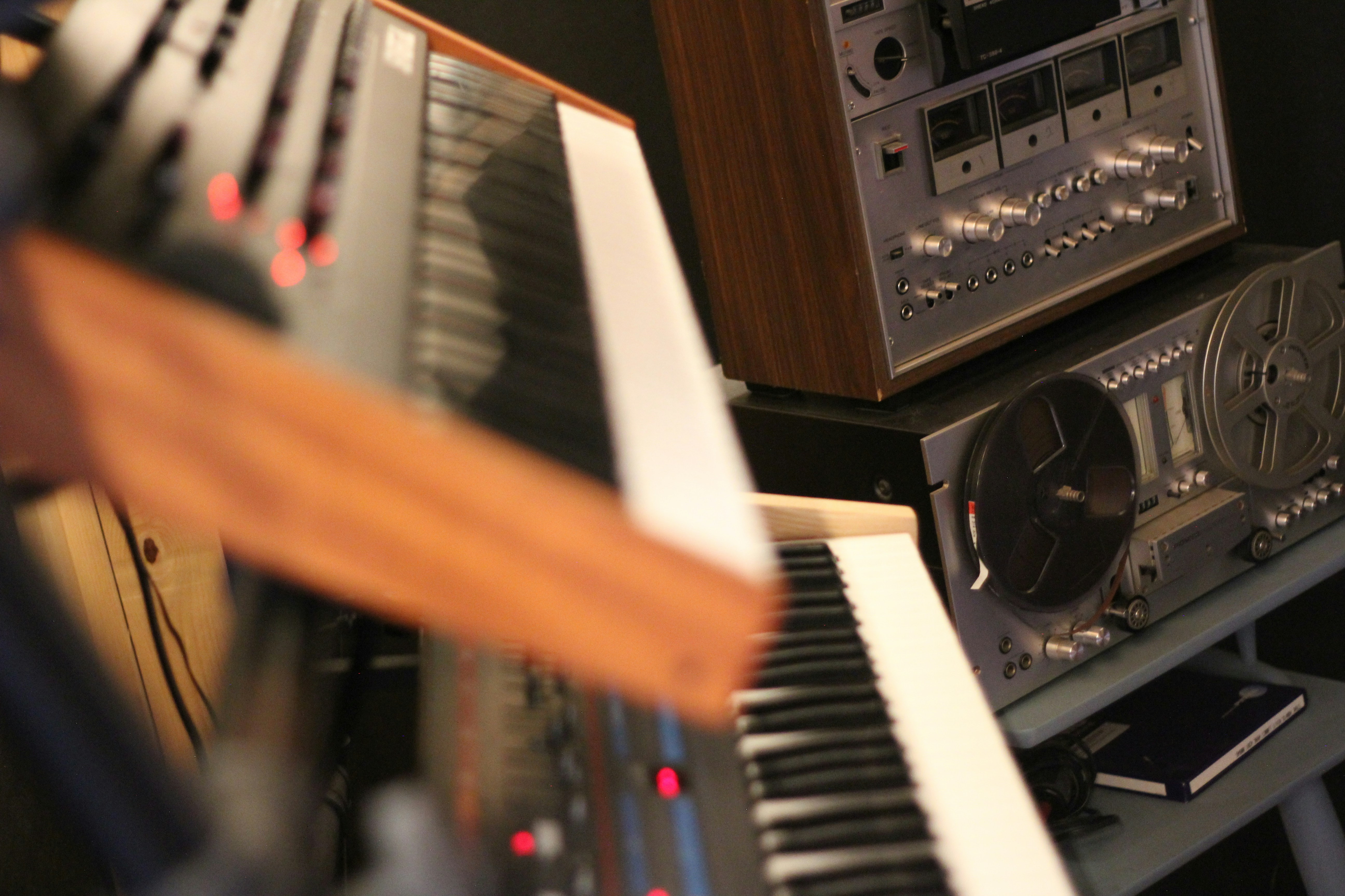 Vintage audio equipment and synthesizers in studio.