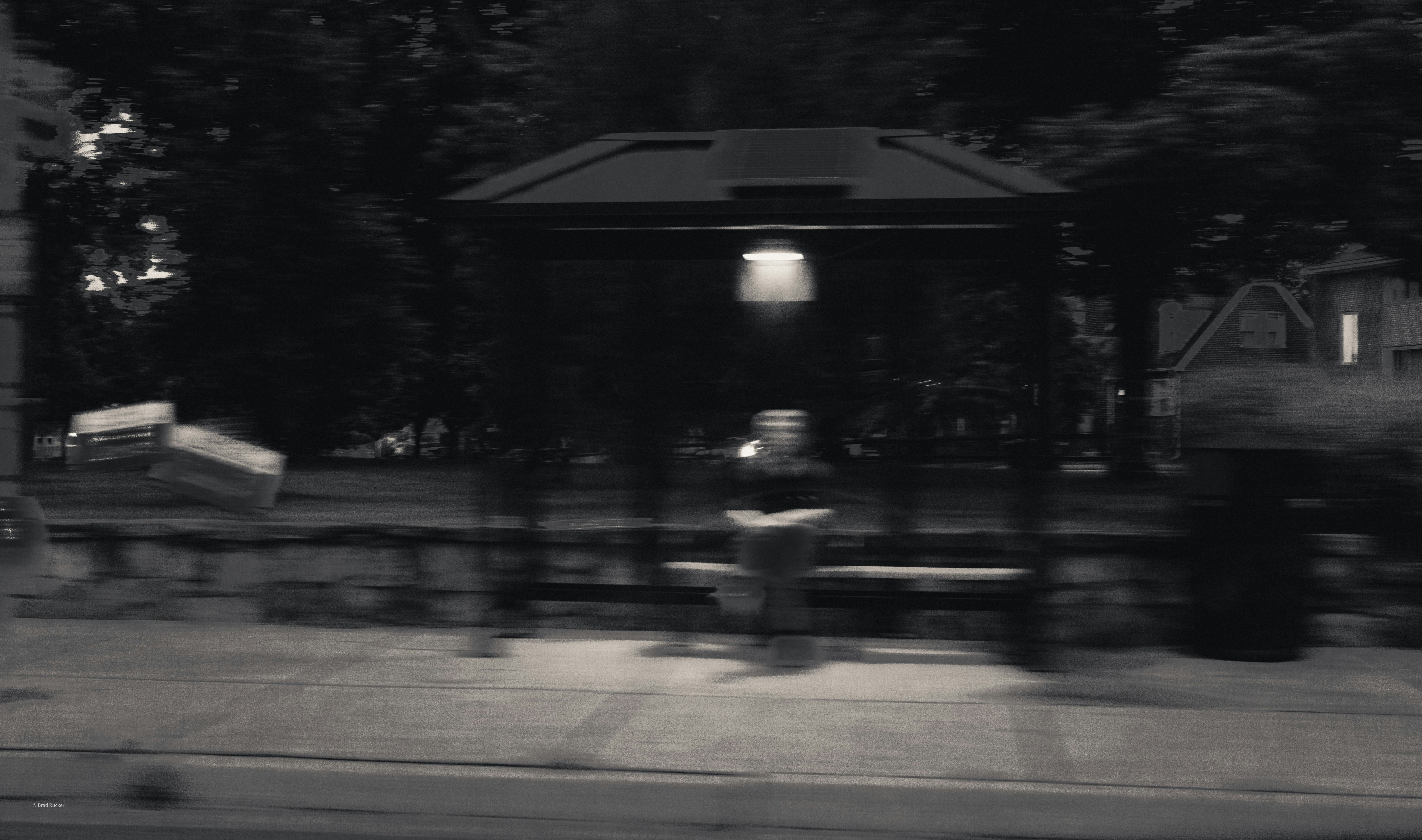 Bus shelter at night under a single light