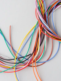 A colorful bundle of electrical wires on a light background.