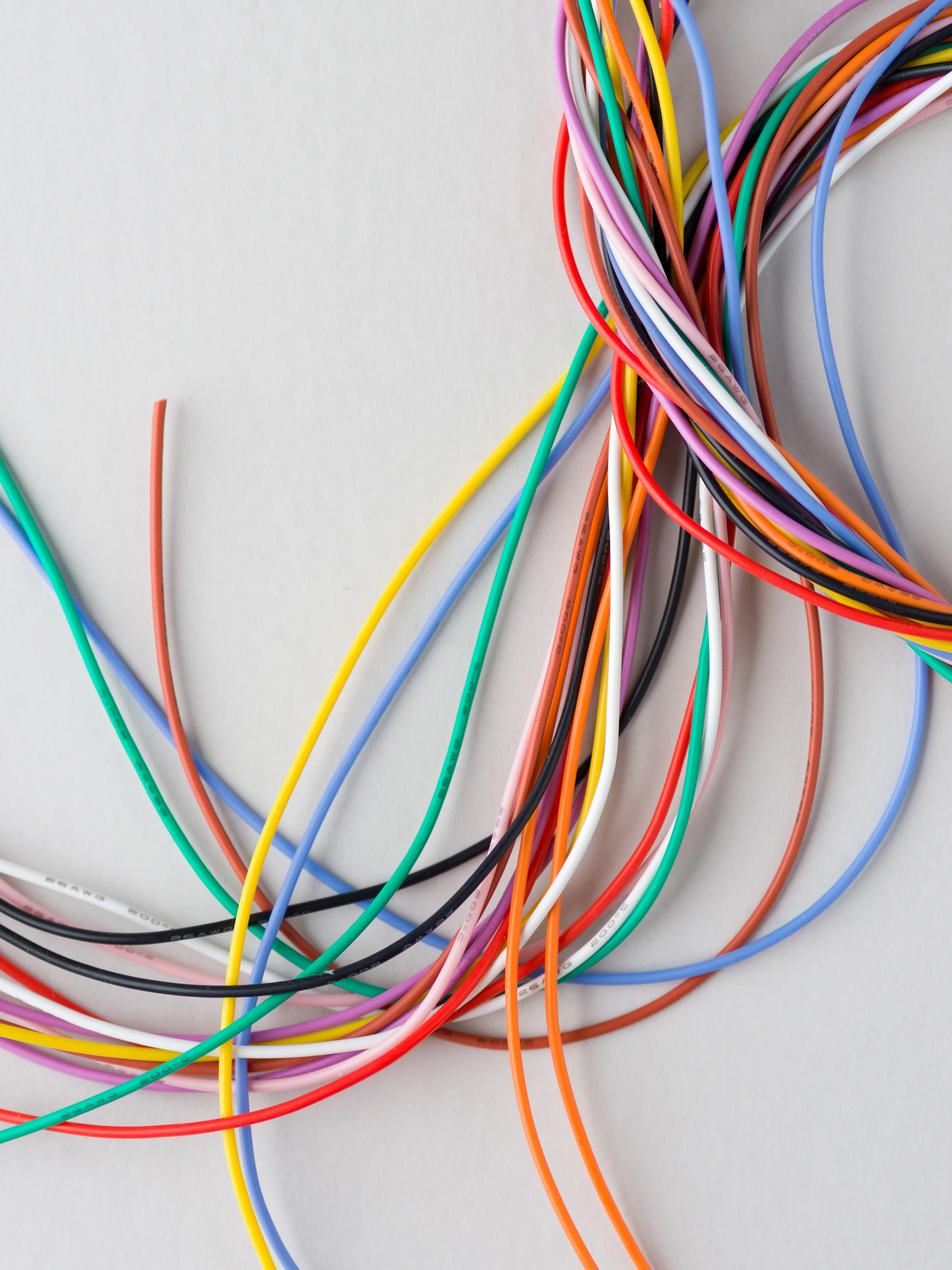 A colorful bundle of electrical wires on a light background.