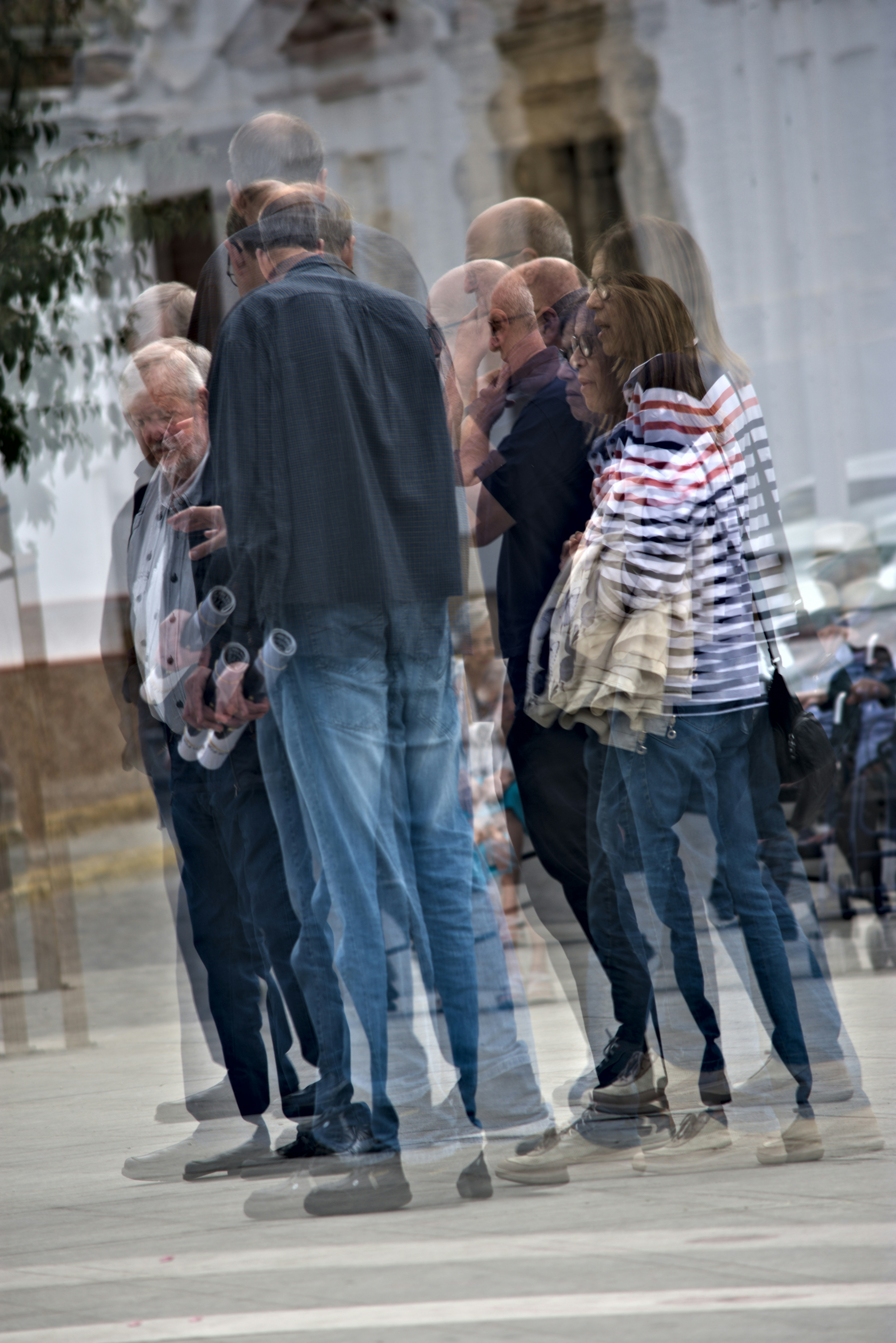 These are people in thye street. This photo has a multiple exposition