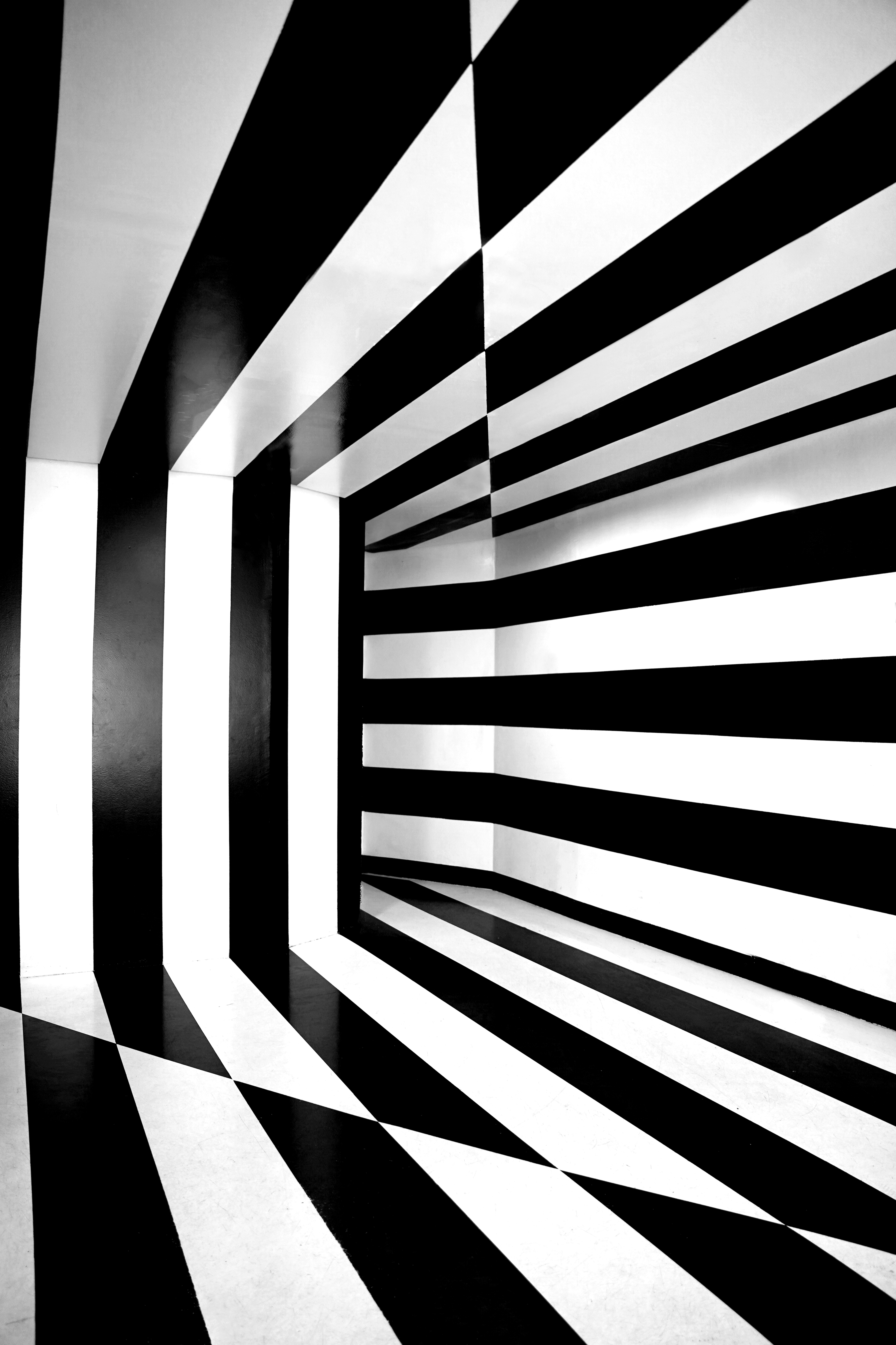 Black and white striped tunnel with checkered floor.