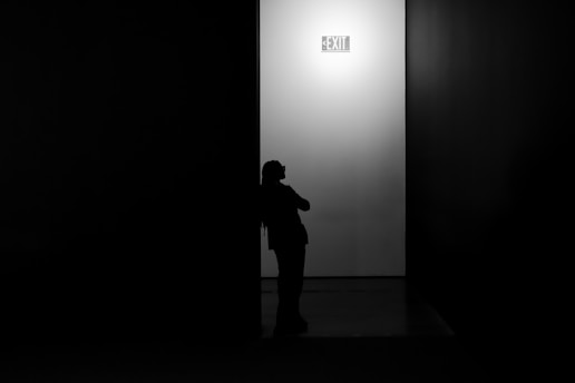 Silhouette of a person against a bright wall