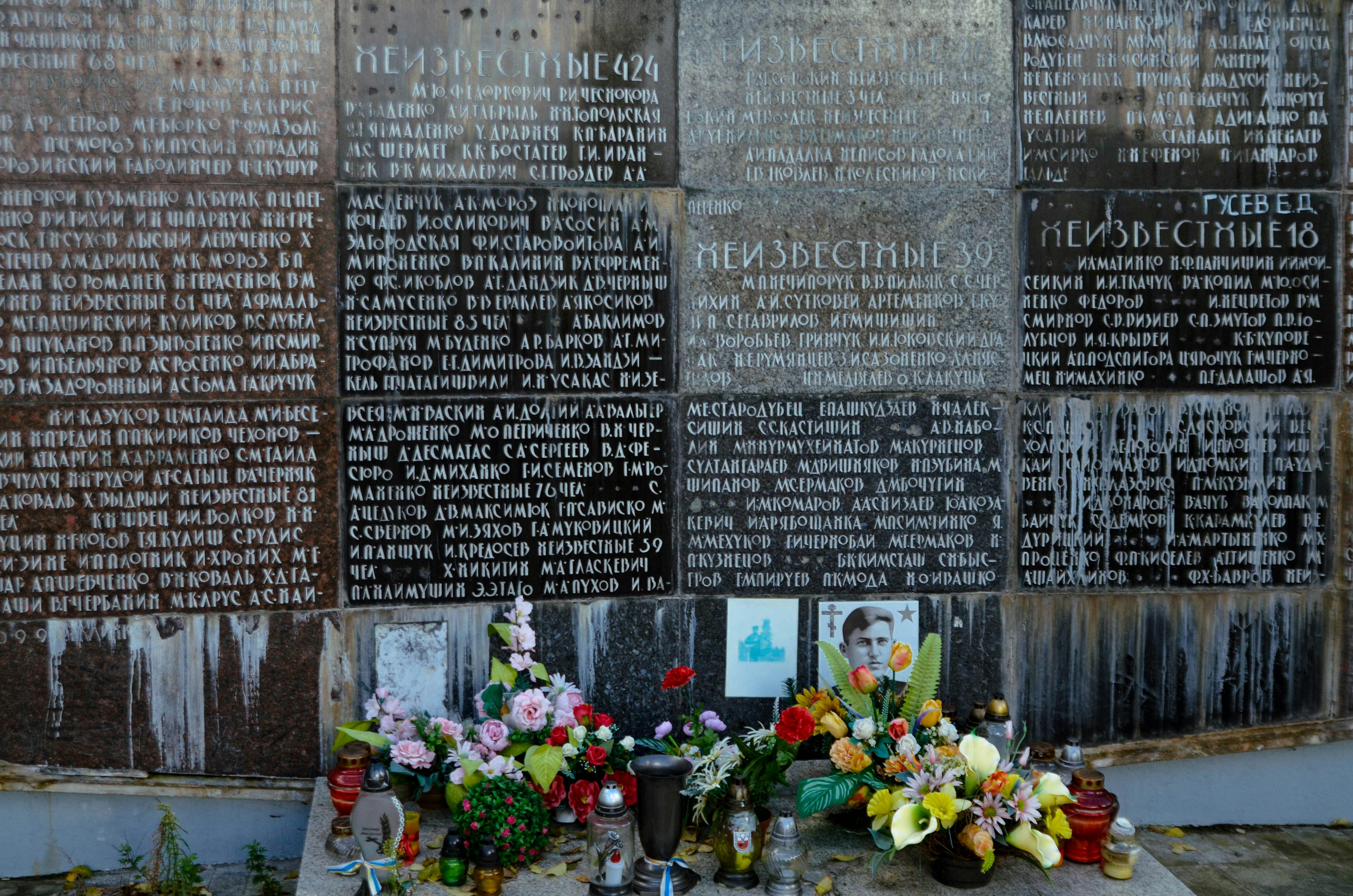 Memorial wall with flowers and photographs
