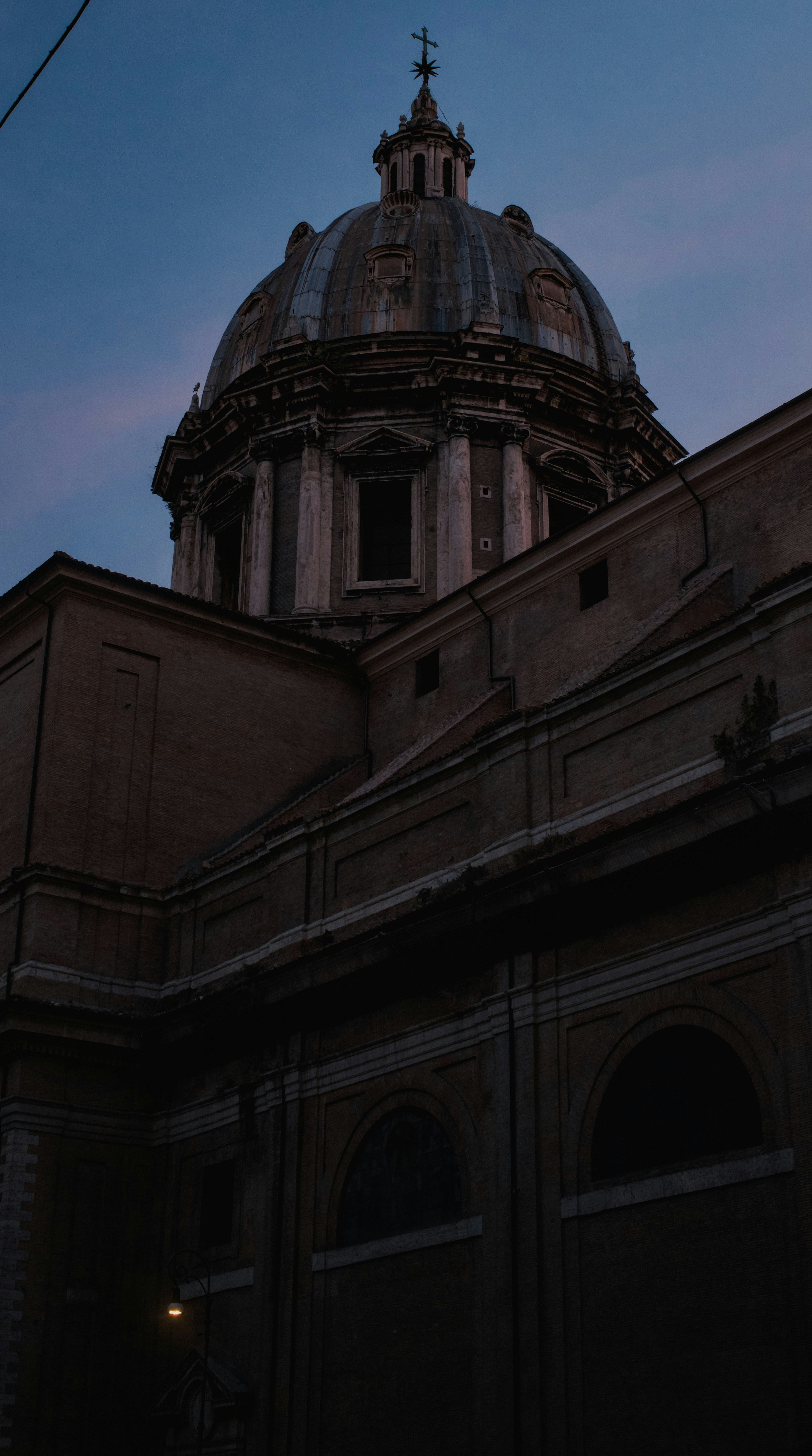 Grand dome of a historic building against twilight sky.