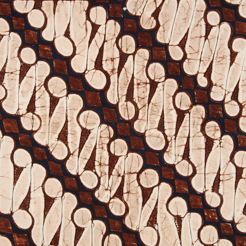 Brown and cream batik fabric with repeating traditional pattern