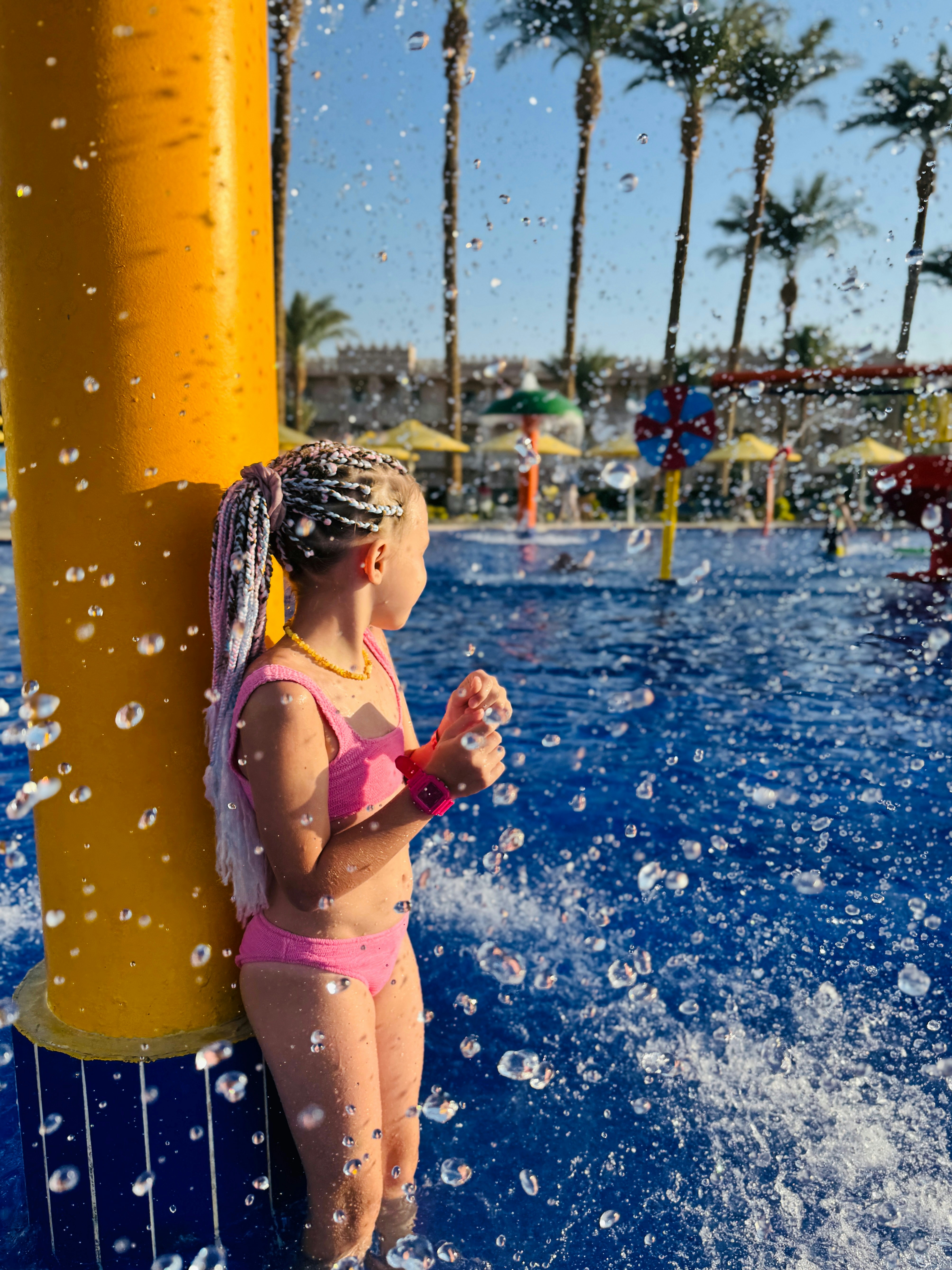 Girl in pink bikini at water park