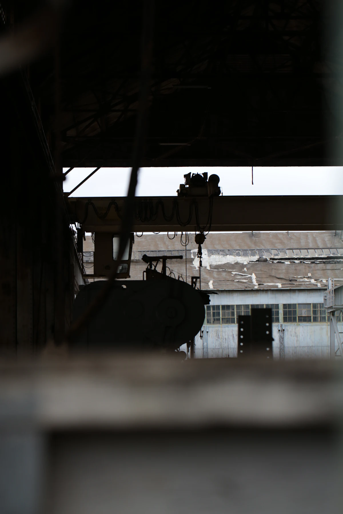 Overhead crane and hoist inside an industrial warehouse